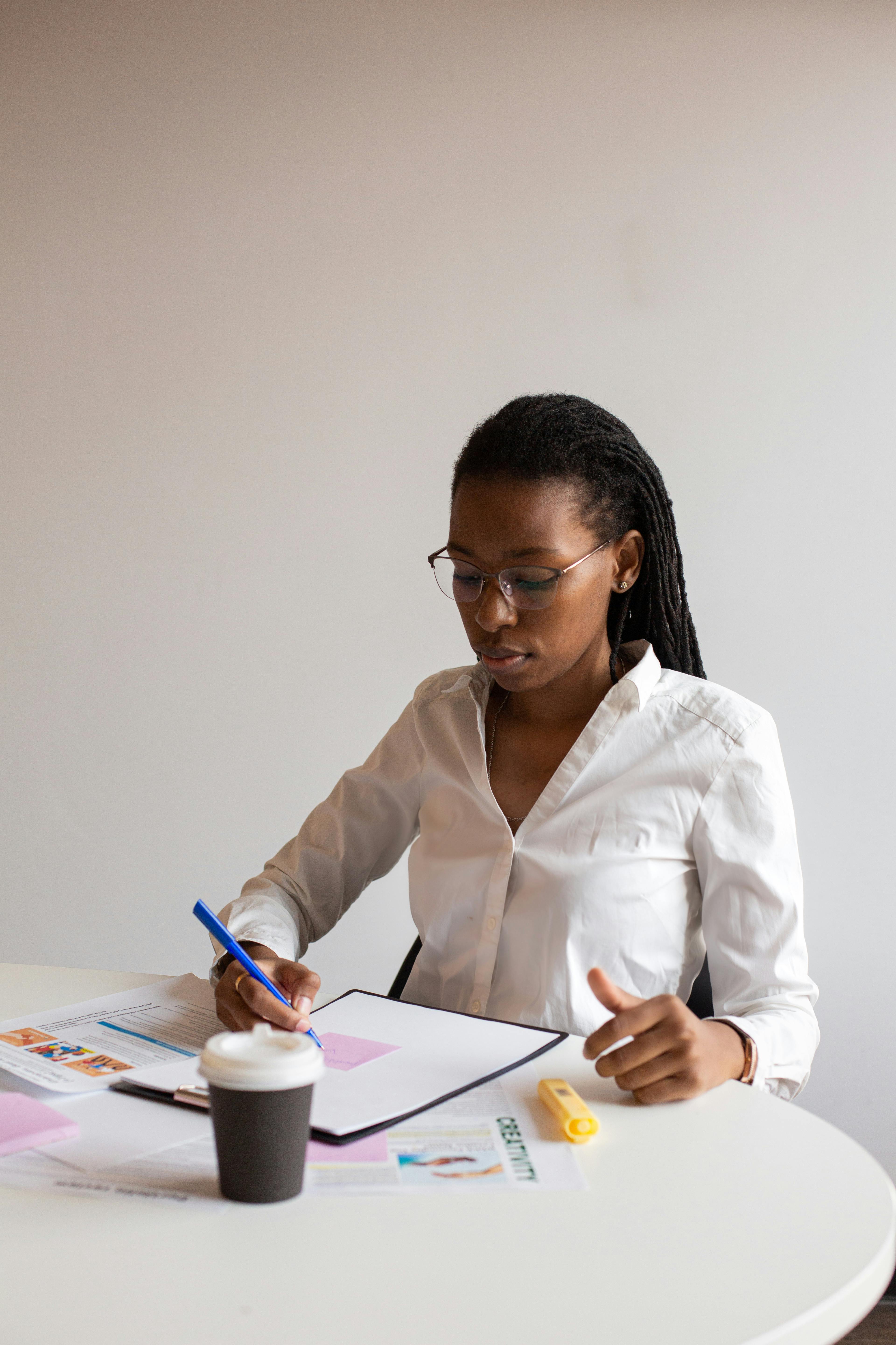 Education professional reviewing documents and recording inspection notes
